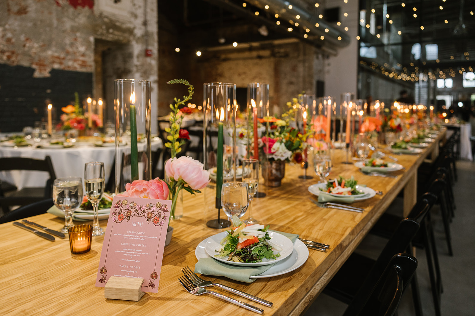 reception table setup under bistro lights at the butterfly room wedding venue in baltimore