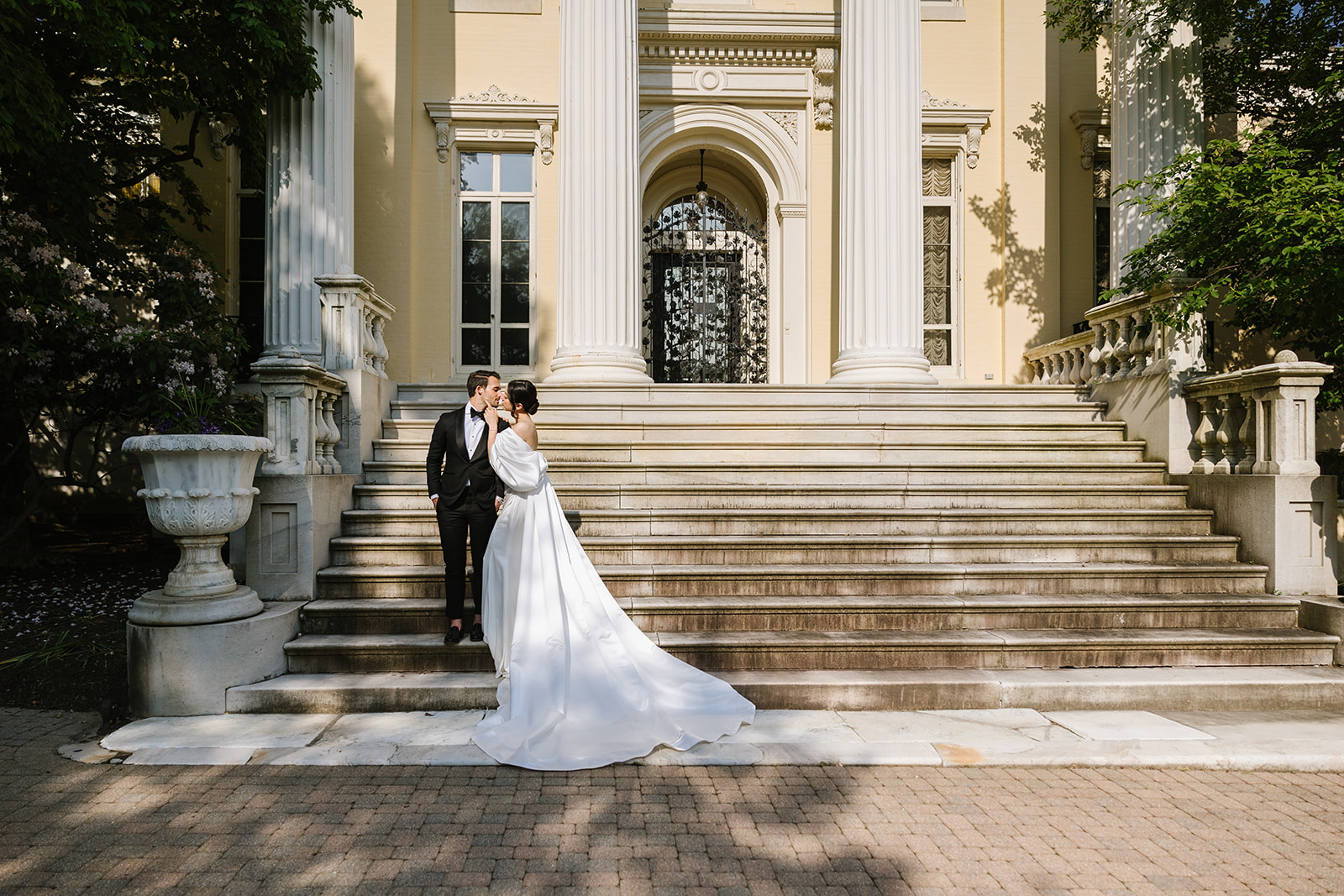 bride and groom standing in front of evergreen museum and library in baltimore, md
