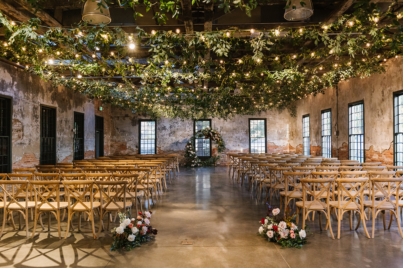 hanging greenery ceiling installation at mt washington mill dye house wedding ceremony