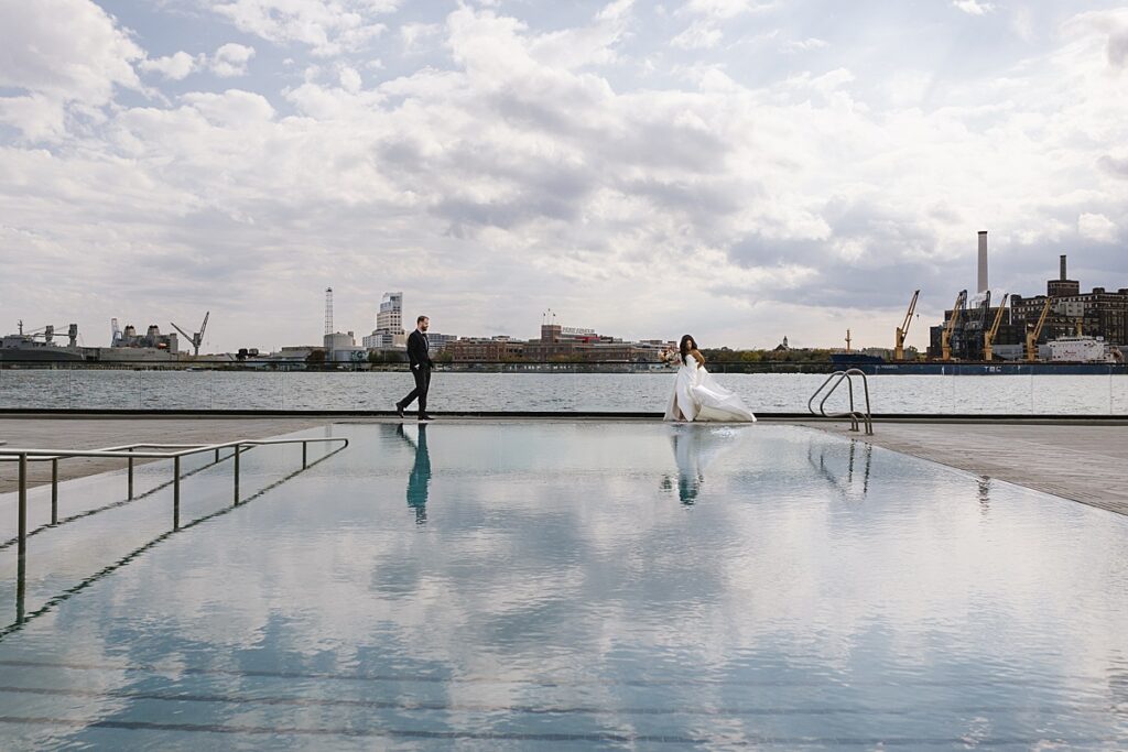 wedding couple approaching each other on pool deck of the sagamore pendry in baltimore